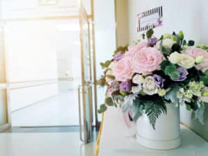 Get well soon wishing card with flower on the table in front of ICU room in hospital